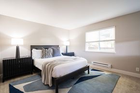 Larkspur apartment for rent - A bedroom with a large bed and a window.