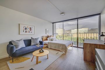 Salt Lake City apartment for rent - a living room with a couch and a bed and a balcony