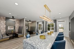 Charlotte apartment for rent - A modern dining room with a marble table and blue chairs.