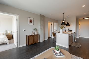 Minneapolis apartment for rent - A modern living room with a wooden coffee table and a white sofa.