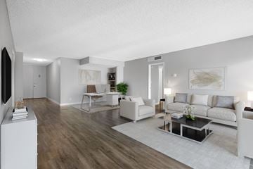 Los Angeles apartment for rent - A modern living room with a white sofa set and a wooden floor.