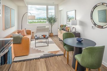 Tigard apartment for rent - a living room with a couch and a table and a window
