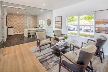 Tigard apartment for rent - A living room with a glass table and chairs.