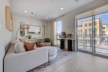 Salt Lake City apartment for rent - A living room with a grey couch and a large window.