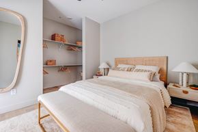 Salt Lake City apartment for rent - A bedroom with a large bed and a mirror on the wall.