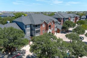 San Antonio apartment for rent - A bird's eye view of an apartment building surrounded by trees at The Quarry Alamo Heights Apartments, San Antonio, TX, 78209