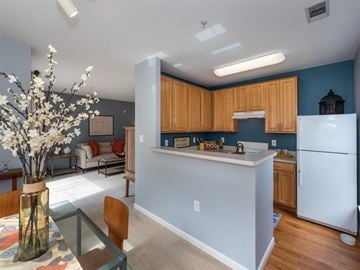 Germantown apartment for rent - a kitchen and living room with a refrigerator and a table