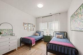 Charlotte townhouse for rent - A bedroom with two beds and a dresser.