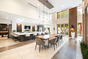 Monrovia apartment for rent - A modern dining room with a long table and chairs.