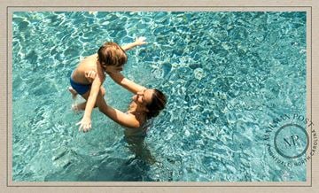Knightdale apartment for rent - A child is being held up by an adult in a pool.
