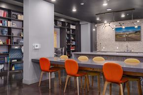 Louisville apartment for rent - A modern dining room with a grey table and orange chairs.