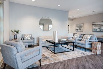 Louisville apartment for rent - A living room with grey chairs and a coffee table.
