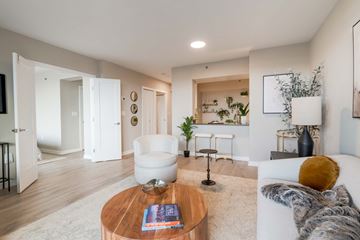 Arlington apartment for rent - A modern living room with a white sofa and a coffee table.