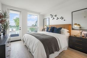 San Jose apartment for rent - a bedroom with a large bed and two windows