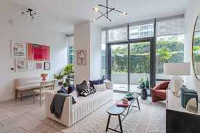 Miami apartment for rent - A living room with a sofa, a table, and a couch.