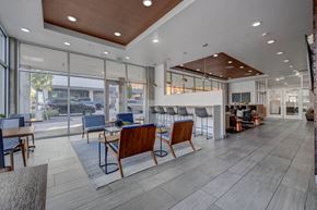 Salt Lake City apartment for rent - A spacious waiting area with wooden chairs and a glass wall overlooking the street.