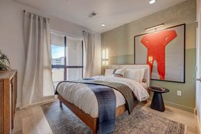 Salt Lake City apartment for rent - A bedroom with a large bed and a red abstract painting on the wall.