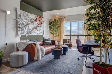Salt Lake City apartment for rent - A living room with a large couch and a tree.