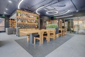 Salt Lake City apartment for rent - A modern dining area with wooden furniture and a wall of shelves with decorative items.