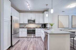 Alexandria apartment for rent - a kitchen with white cabinets and stainless steel appliances