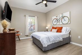 Copperas Cove apartment for rent - A bedroom with a large bed and a television on the wall at Clear Creek Meadows Apartments, Copperas Cove, 76522