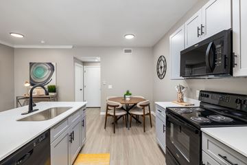 Copperas Cove apartment for rent - A modern kitchen with a table and chairs in the middle.