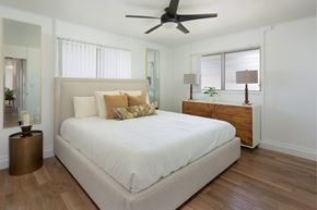 Ewa Beach apartment for rent - a bedroom with a large white bed and a ceiling fan