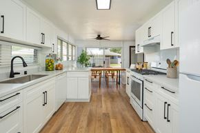 Ewa Beach apartment for rent - a large kitchen with white cabinets and a wooden floor