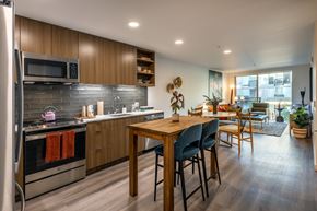 Seattle apartment for rent - A modern kitchen with a wooden table and chairs.