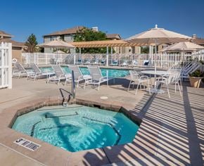 Riverton apartment for rent - A pool with a hot tub and sun loungers.