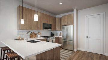 Plymouth Meeting apartment for rent - A modern kitchen with wooden cabinets and a white countertop.
