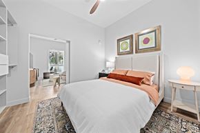Scottsdale apartment for rent - a bedroom with a large bed and a closet ceiling fan