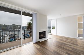 Marina Del Rey apartment for rent - A living room with a fireplace and sliding glass doors.