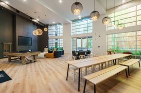 San Jose apartment for rent - a communal room with tables and chairs and a pool table