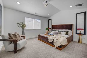 Herriman apartment for rent - A bedroom with a large bed and a chair.