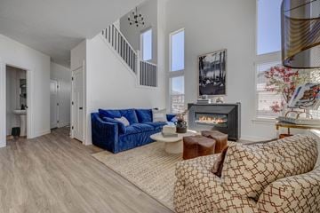 Herriman apartment for rent - A living room with a blue couch and a fireplace.