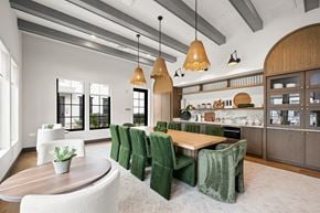 Charleston apartment for rent - A modern kitchen with green chairs and wooden furniture.