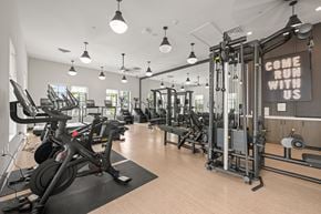 Charleston apartment for rent - A gym with a sign that says "Come run with us" is shown.