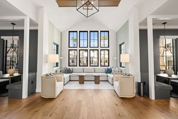 Charleston apartment for rent - A modern living room with a large sectional sofa and a wooden floor.