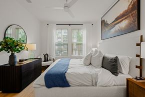 Charleston apartment for rent - A bedroom with a large bed and a painting on the wall.