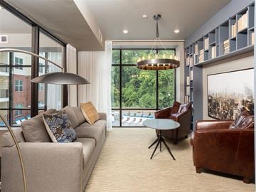 Charlotte apartment for rent - a living room with a couch and a chair and a large window