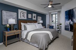 Tampa apartment for rent - A bedroom with a large bed and a ceiling fan.