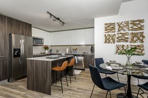 Tampa apartment for rent - A modern kitchen with a dining table set for two.