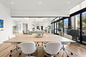 Miami apartment for rent - A modern dining room with a large table and chairs.