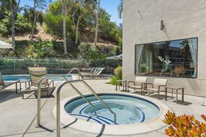 San Diego apartment for rent - A hot tub with lounge chairs.