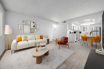 Avondale apartment for rent - A living room with a white couch and orange accents.