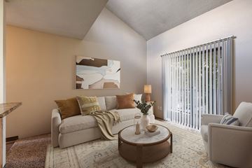Albuquerque apartment for rent - A living room with a couch, a coffee table, and a painting on the wall.