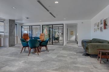 South Salt Lake apartment for rent - A living room with a grey carpet and a green sofa.