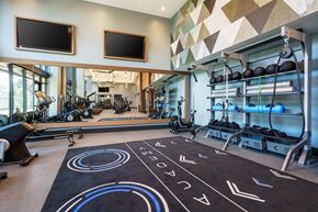 Burlingame apartment for rent - a gym with weights and weights on a floor and a wall of windows