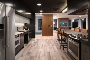 Seattle apartment for rent - a kitchen with stainless steel appliances and a large island with chairs at Orion, Seattle, WA, 98109